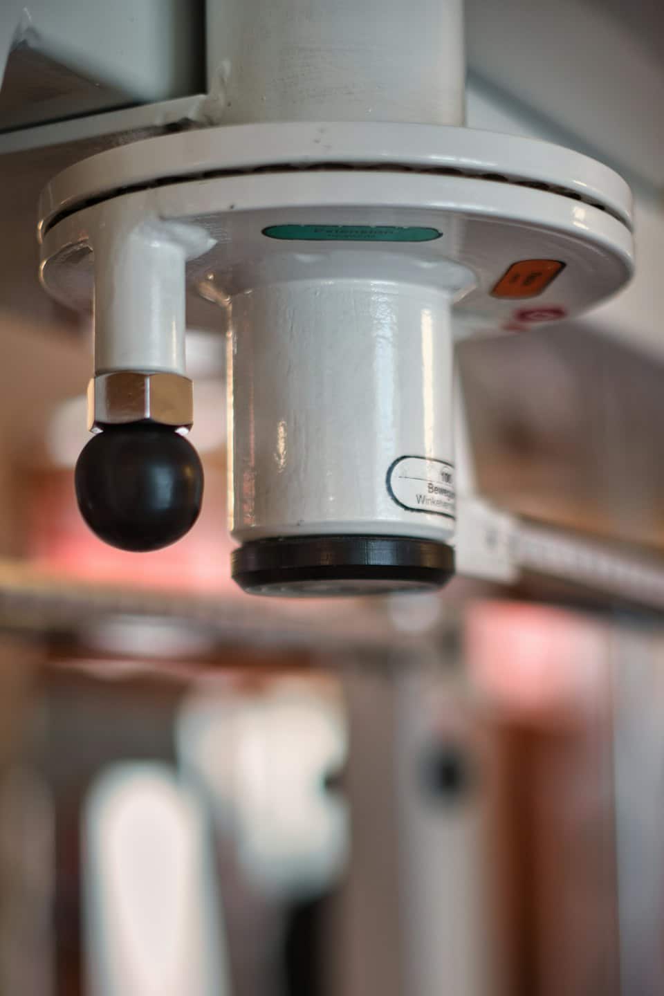 A white industrial sensor with a spherical component attached.