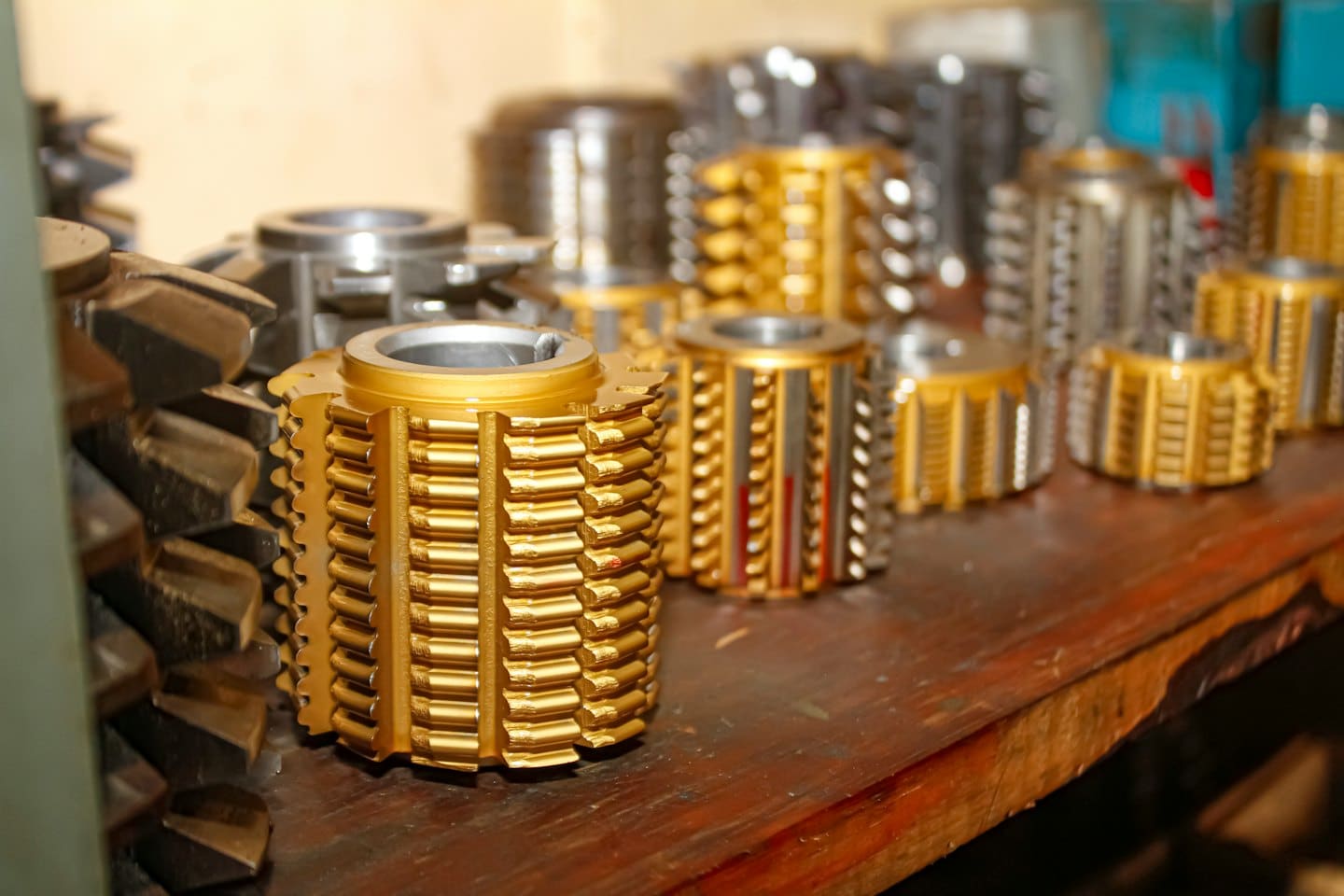 Industrial cutting tools arranged on a wooden workbench.